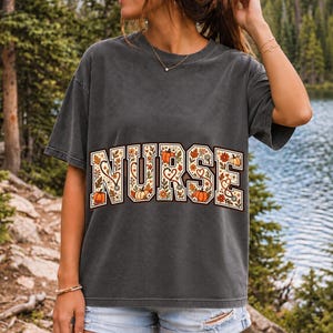 Arched varsity word NURSE filled with autumn leaves, stethoscopes and pumpkins in cream, rust and mustard
