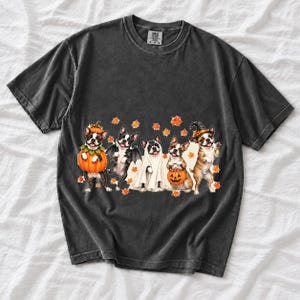Five watercolor Boston terriers in Halloween costumes with falling autumn leaves