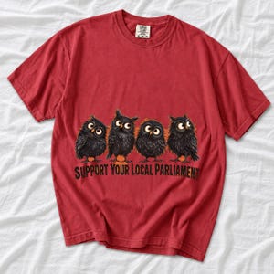 Four fluffy big-eyed black owls in a row with the text "Support Your Local Parliament"