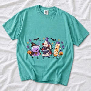 Kawaii beaker, microscope and test tube with faces in Halloween costumes, pastel purple and orange