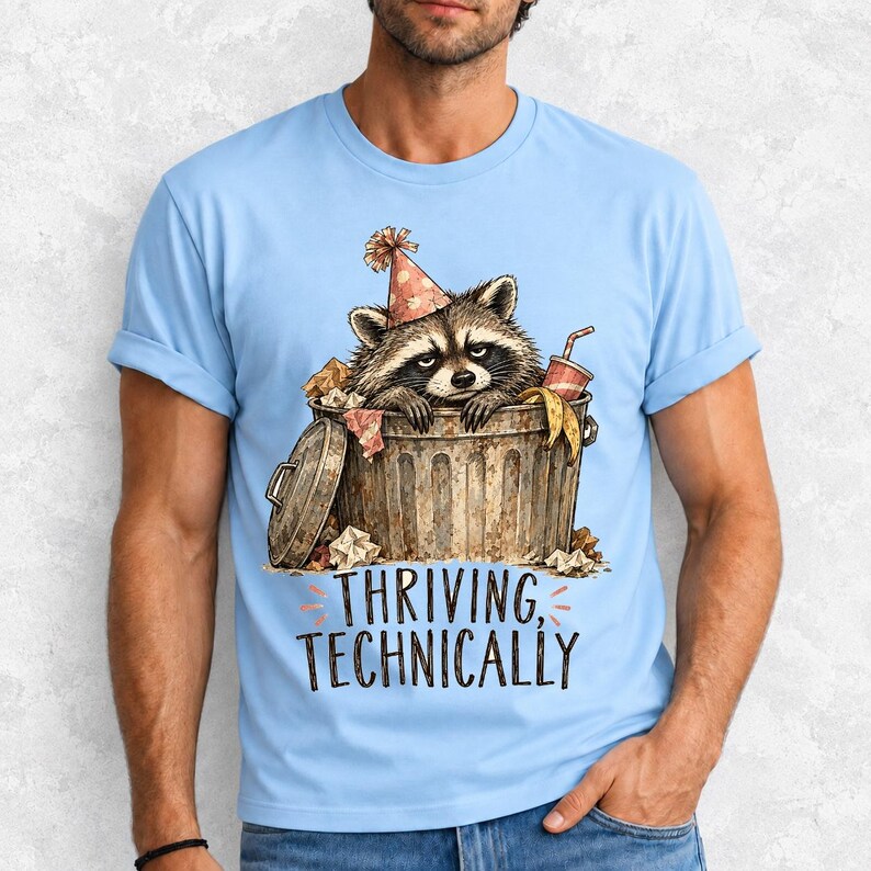 Raccoon in a paper party hat peeking out of a trash can with the text "Thriving, Technically", sepia watercolor sketch