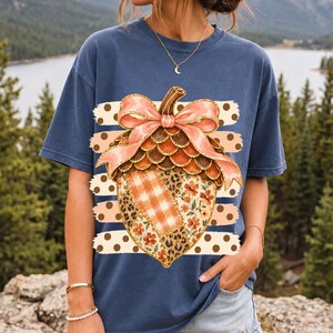 Giant patchwork acorn with a pink satin bow made of plaid, leopard and floral fabric on polka-dot stripes
