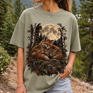 Fox family curled on a rock under a huge full moon among birch trees, dark realistic woodland illustration