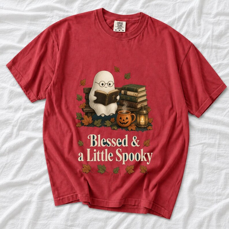 Cute ghost with glasses reading a Bible with a candle and mug, text "Blessed & a Little Spooky", retro fall illustration