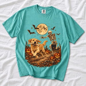 A skeleton chasing a golden labrador that stole its arm bone under a full moon with jack o lanterns and bats