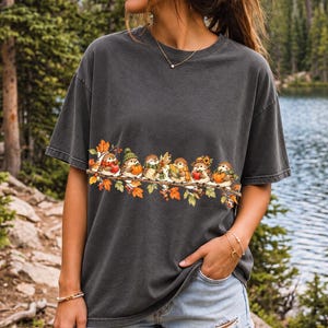 Row of watercolor sparrows on a branch holding tiny apples, corn and a pumpkin for harvest