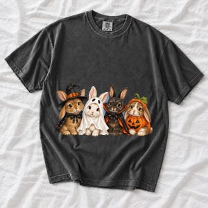 Realistic illustration of four bunnies in witch, ghost, vampire cape and pumpkin costumes in a row