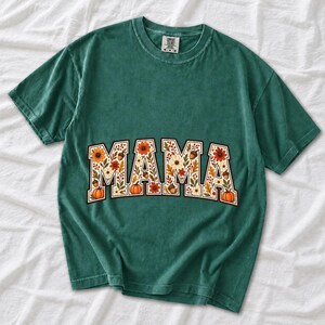 Arched varsity word MAMA filled with fall flowers and acorns in cream, rust and mustard