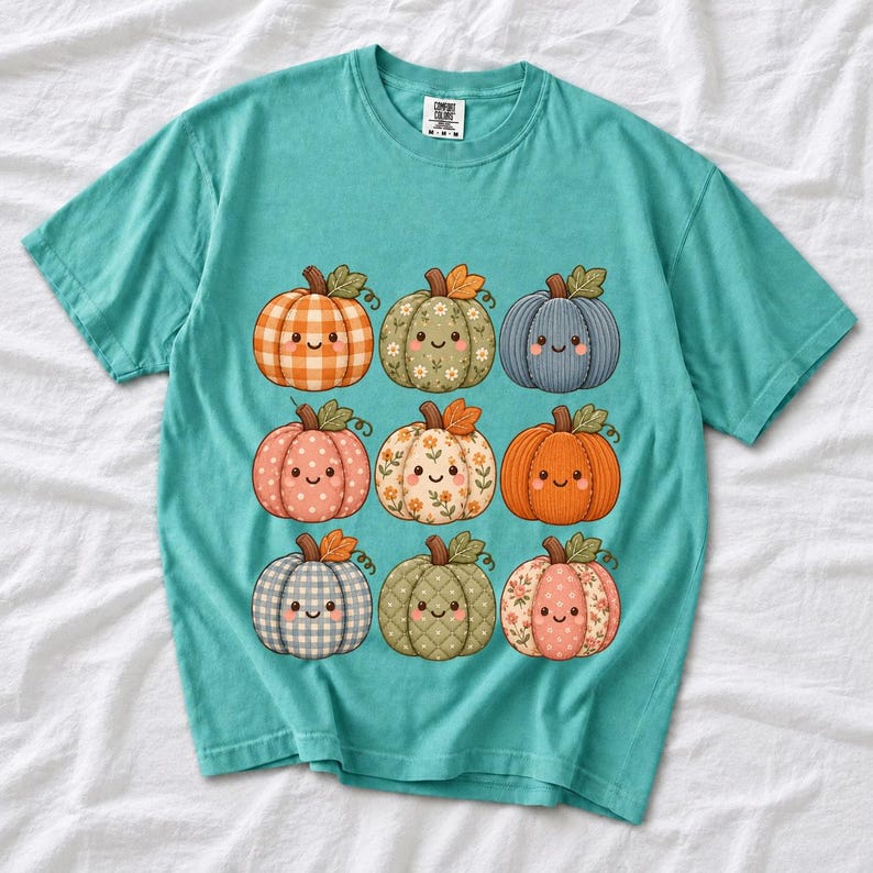 Grid of smiling pumpkins sewn from gingham, floral and corduroy patchwork fabric in autumn colors