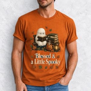 Cute ghost with glasses reading a Bible with a candle and mug, text "Blessed & a Little Spooky", retro fall illustration