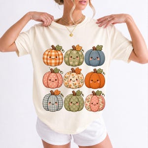 Grid of smiling pumpkins sewn from gingham, floral and corduroy patchwork fabric in autumn colors