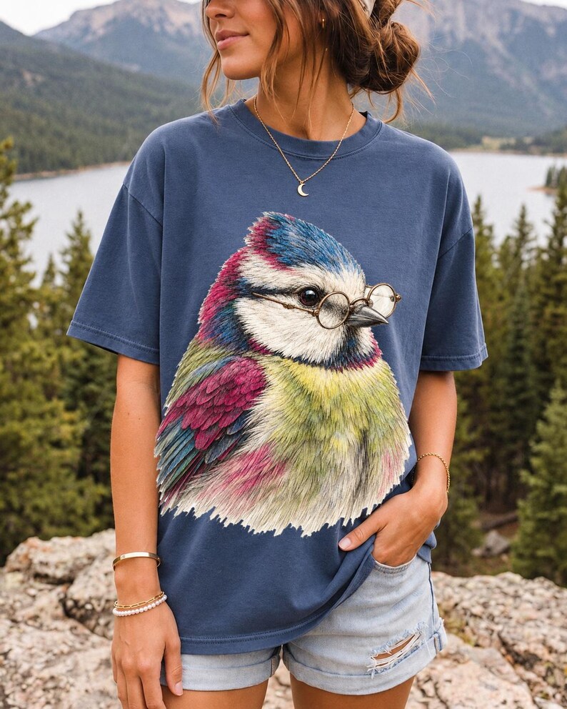 Colored-pencil blue tit bird wearing tiny round reading glasses, funny birdwatcher t-shirt illustration