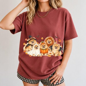 Five fluffy watercolor pomeranians in Halloween costumes with autumn leaves and bats