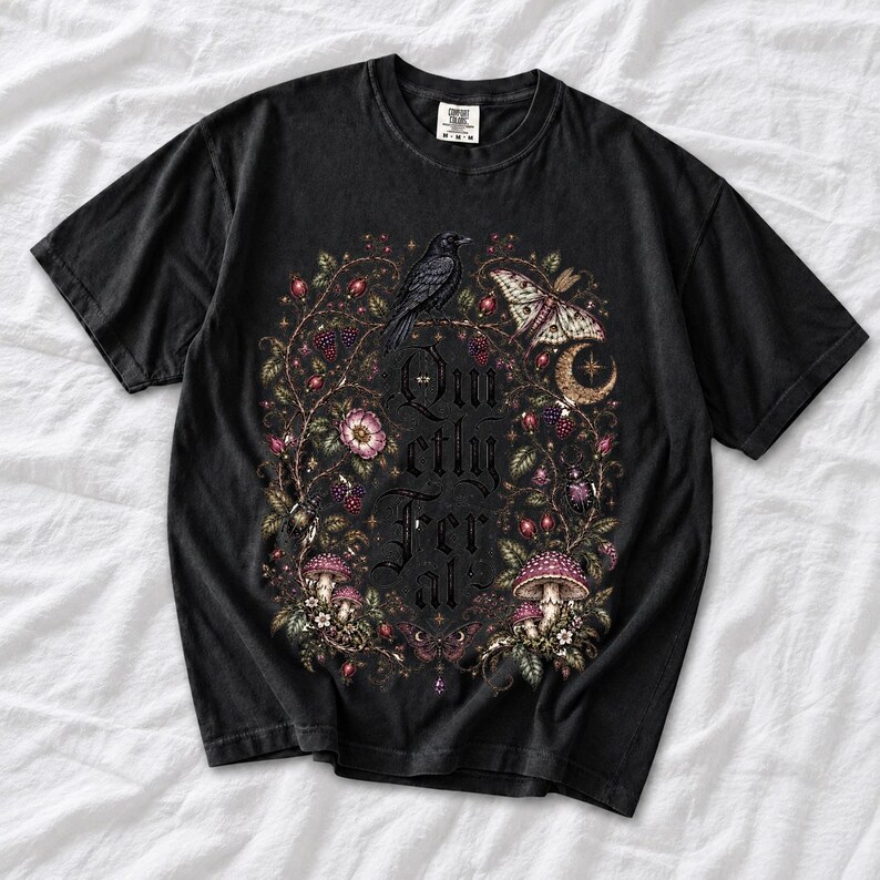 Raven on a wild rose branch with beetles and berries around blackletter text "Quietly Feral"