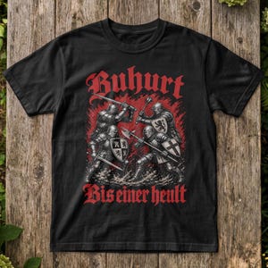 May include: A black short-sleeved t-shirt featuring a graphic of four armoured knights in combat with swords and maces. The design includes red text that reads Buhurt at the top and Bis einer heult at the bottom, set against a red background.