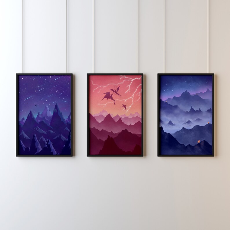 May include: Three framed illustrations of mountain ranges with different color palettes. The first image is a dark blue and purple mountain range with a starry night sky. The second image is a red and purple mountain range with a pink sky and three flying dragons. The third image is a blue and purple mountain range with a foggy sky and a few small lights.