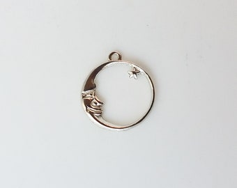 May include: Silver charm in the shape of a crescent moon with a small star at the top. The moon has a face sculpted into it.