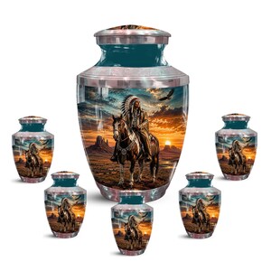 May include: A large central cremation urn surrounded by five smaller matching keepsake urns. Each urn features a teal lid and a metallic band, displaying a detailed scene of a person in traditional headdress riding a horse at sunset.