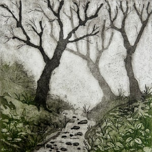 May include: A black and white print depicting a forest scene with two bare trees and a stream running through the centre. The stream is filled with small, round stones. The trees are silhouetted against a light grey background.