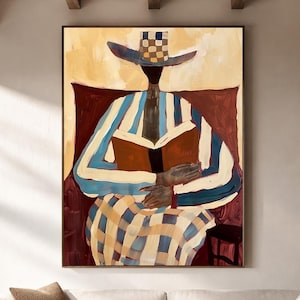 May include: A framed wall art print depicting a stylized figure wearing a wide-brimmed hat with a checkered crown, a blue and white striped long-sleeve top, and a checkered skirt, while holding an open brown book against a dark red background.