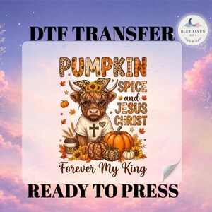 May include: A DTF transfer sheet featuring a highland cow wearing a leopard print headband and heart-shaped glasses. The text reads PUMPKIN SPICE and JESUS CHRIST Forever My King. The design includes pumpkins, sunflowers, and a coffee cup.
