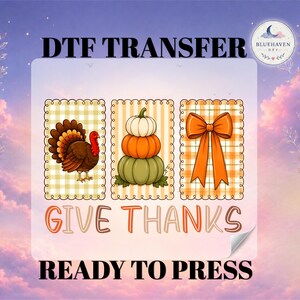 May include: A DTF transfer sheet featuring three rectangular panels with scalloped edges on a plaid background. The panels display a turkey, a stack of three pumpkins, and an orange bow. The text reads DTF TRANSFER, GIVE THANKS, and READY TO PRESS.