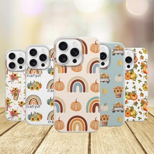 May include: Five smartphone cases featuring autumn-themed patterns. Designs include pumpkins, sunflowers, rainbows, and trucks in shades of orange, blue, and cream. The cases display various seasonal motifs like falling leaves and the text It's fall y'all.