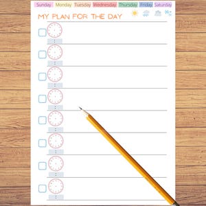 May include: A daily planner sheet titled MY PLAN FOR THE DAY with a row of days of the week, weather icons, and seven rows featuring a checkbox, a blank clock face, and a space for minutes. A yellow wooden pencil rests diagonally across the page.