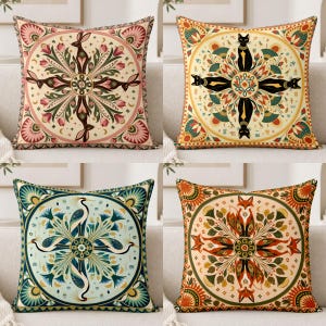 May include: A set of four square throw pillows featuring symmetrical circular patterns. Each pillow displays a central animal motif, including a rabbit, a black cat, a crane, and a fox, surrounded by intricate floral and geometric botanical designs.