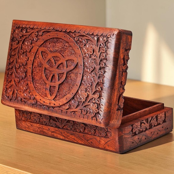 Hand-carved wooden keepsake chest with genuine rustic craft character — each one is different, and $141 signals serious artisan work.