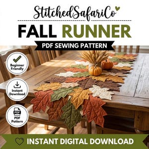 May include: A PDF sewing pattern for a table runner titled StitchedSafariCo Fall Runner. The design features quilted fabric leaves in shades of orange, yellow, brown, and green, arranged in a layered pattern on a wooden table with two small pumpkins.