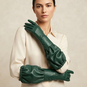 May include: A pair of long, forest green leather gloves featuring a ruched, gathered design extending past the wrist. Each glove includes a row of three matching green buttons along the forearm and an elasticized cuff for a secure fit.