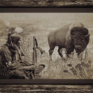 May include: Sepia-toned framed print featuring a Native American figure seated in tall grass, holding a rifle, with a large bison in the background. The image is framed in a rustic wooden frame, with a small American flag emblem in the corner.