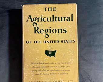 May include: A hardcover book titled The Agricultural Regions of the United States by Ladd Haystead and Gilbert C. Fite. The cover is yellow with dark green text and a graphic of the United States featuring a stalk of wheat in the center.