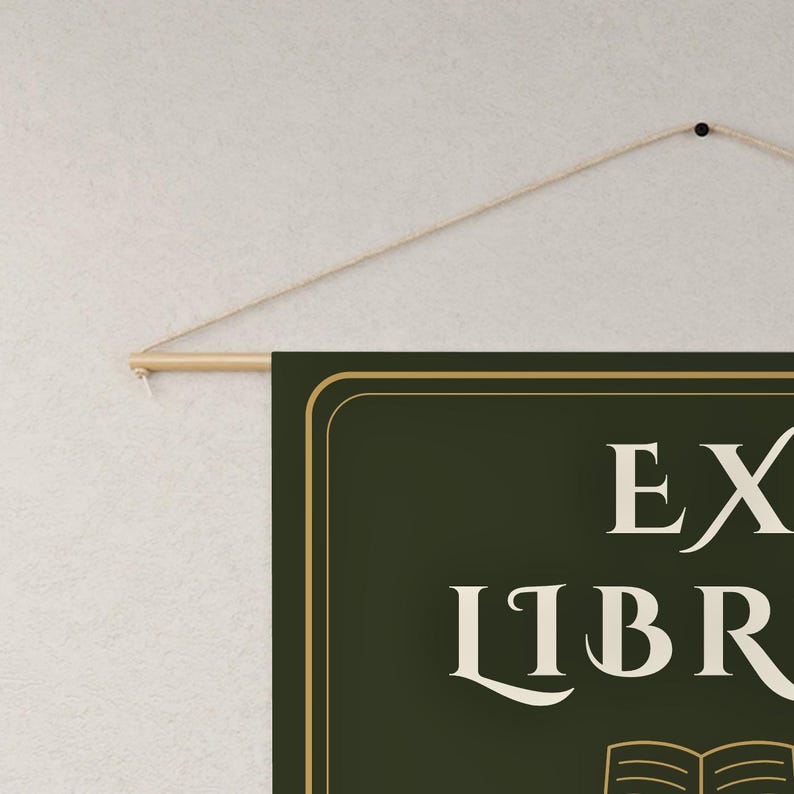 Peut inclure: Une banni&egrave;re murale rectangulaire vert fonc&eacute; avec le texte EX LIBRIS en police serif cr&egrave;me au-dessus d'une ic&ocirc;ne de livre ouvert stylis&eacute;e. La banni&egrave;re est suspendue &agrave; une tige en bois clair avec une fine ficelle beige pour la fixation.