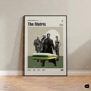May include: A framed movie poster for The Matrix featuring a central graphic of four characters in black trench coats and a prominent green bullet in the foreground. The design includes the title, release year 1999, and cast credits in black text.