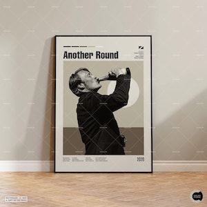 May include: A framed movie poster for Another Round featuring a black and white photograph of a person in a dark suit drinking from a bottle. The poster includes the title Another Round, the year 2020, and small text details in a minimalist layout.