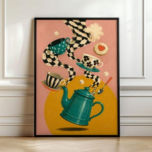 May include: A framed wall art print featuring a teal teapot floating above a yellow circle on a pink background. Three teacups with black and white chequered patterns, floral motifs, and stripes emerge from the teapot, accompanied by sugar cubes and a spoon.