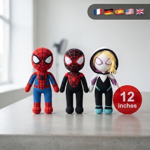 May include: Three handmade crochet dolls standing in a row, each measuring 12 inches tall. The first is red and blue with a spider emblem, the second is black and red with a spider emblem, and the third is white, black, and pink with blonde hair.