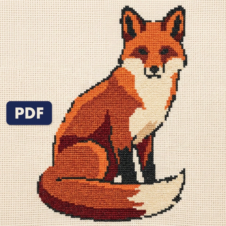 A finished a red fox cross stitch piece, stitched and framed on a wall