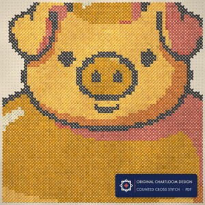 Close up of the pig cross stitch design worked stitch by stitch, every cross and thread colour visible