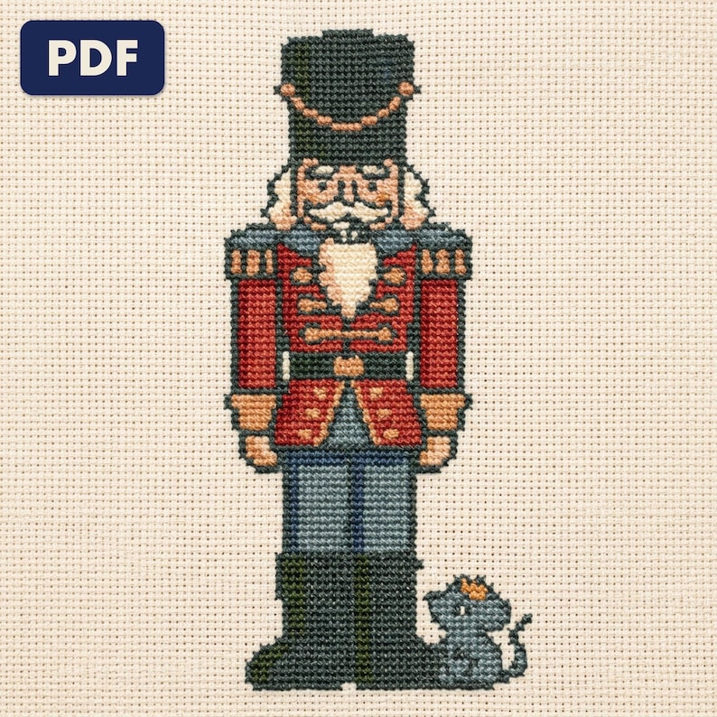 A finished a nutcracker and a mouse king cross stitch piece, stitched and framed on a wall