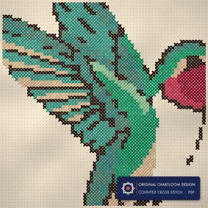 Close up of the a hummingbird cross stitch design worked stitch by stitch, every cross and thread colour visible