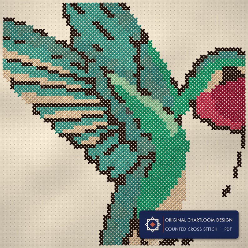 Close up of the a hummingbird cross stitch design worked stitch by stitch, every cross and thread colour visible