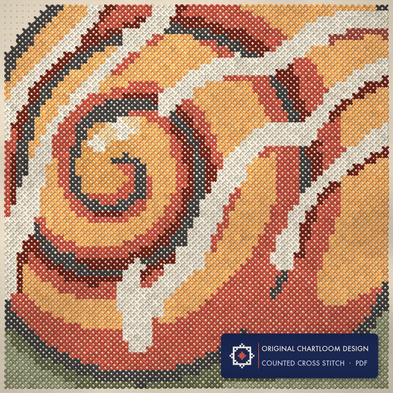 Close up of the snail cross stitch design worked stitch by stitch, every cross and thread colour visible