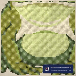 Close up of the a garden frog cross stitch design worked stitch by stitch, every cross and thread colour visible