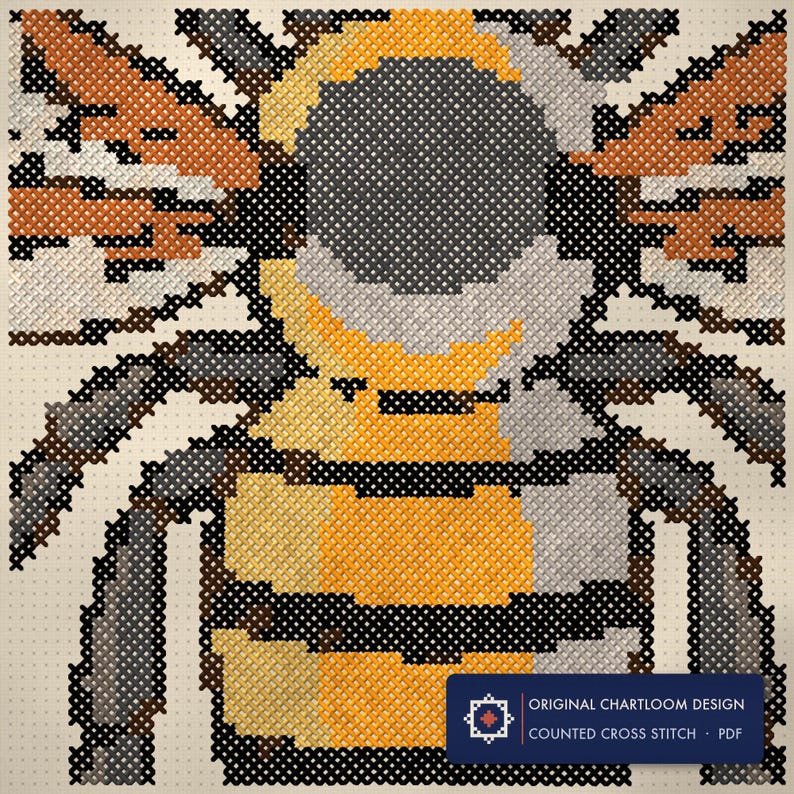 Close up of the a honeybee cross stitch design worked stitch by stitch, every cross and thread colour visible