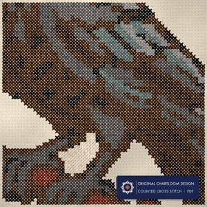 Close up of the raven on a bare branch cross stitch design worked stitch by stitch, every cross and thread colour visible