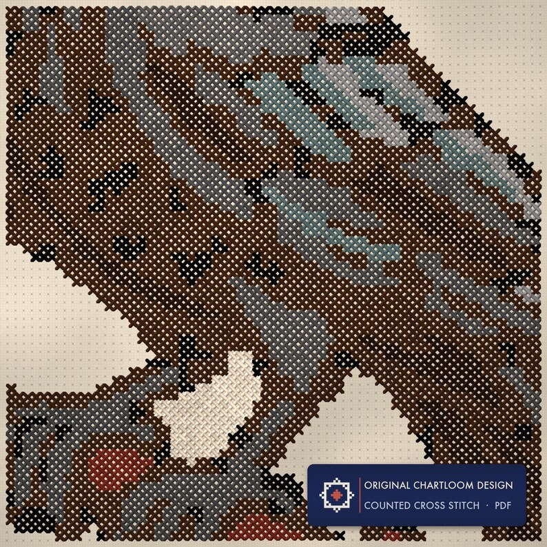 Close up of the raven on a bare branch cross stitch design worked stitch by stitch, every cross and thread colour visible