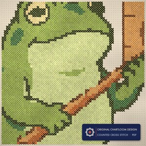 Close up of the frog weather bureau cross stitch design worked stitch by stitch, every cross and thread colour visible